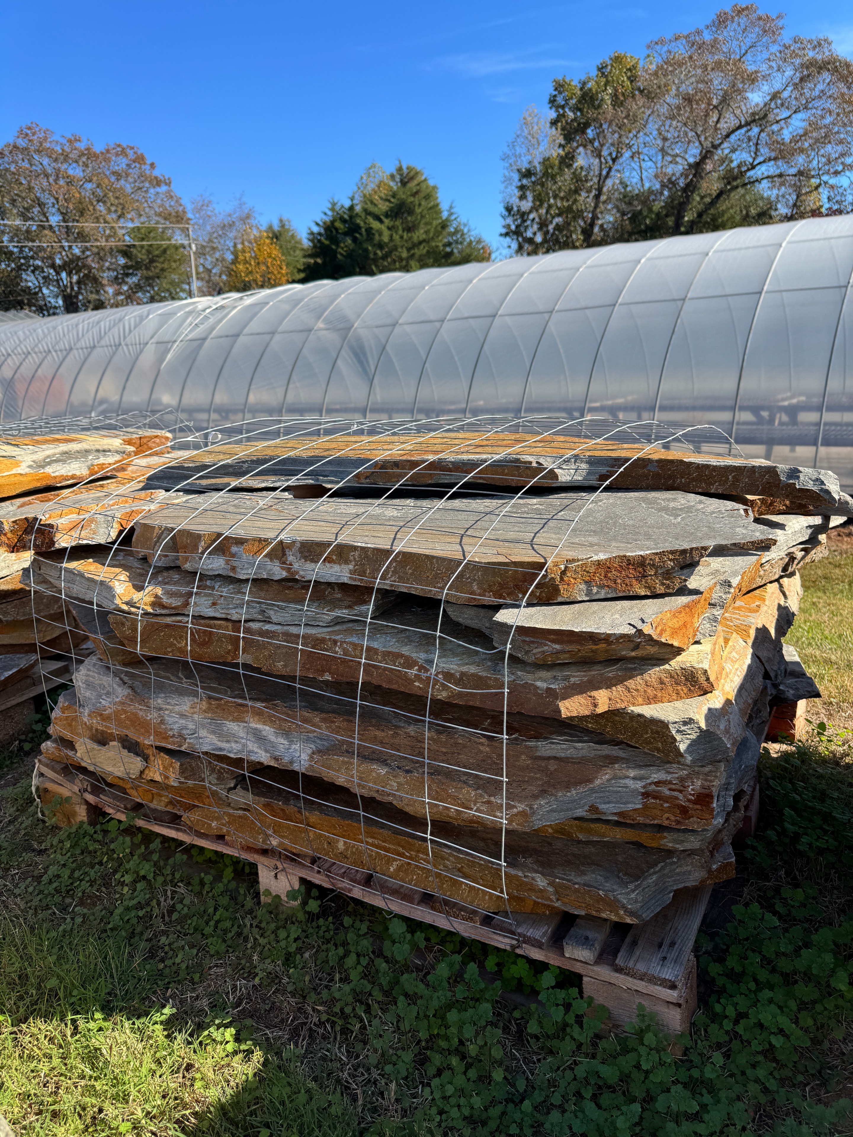 Wire-bound pallet of natural Mountain Mist flagstone slabs standing at the stone yard