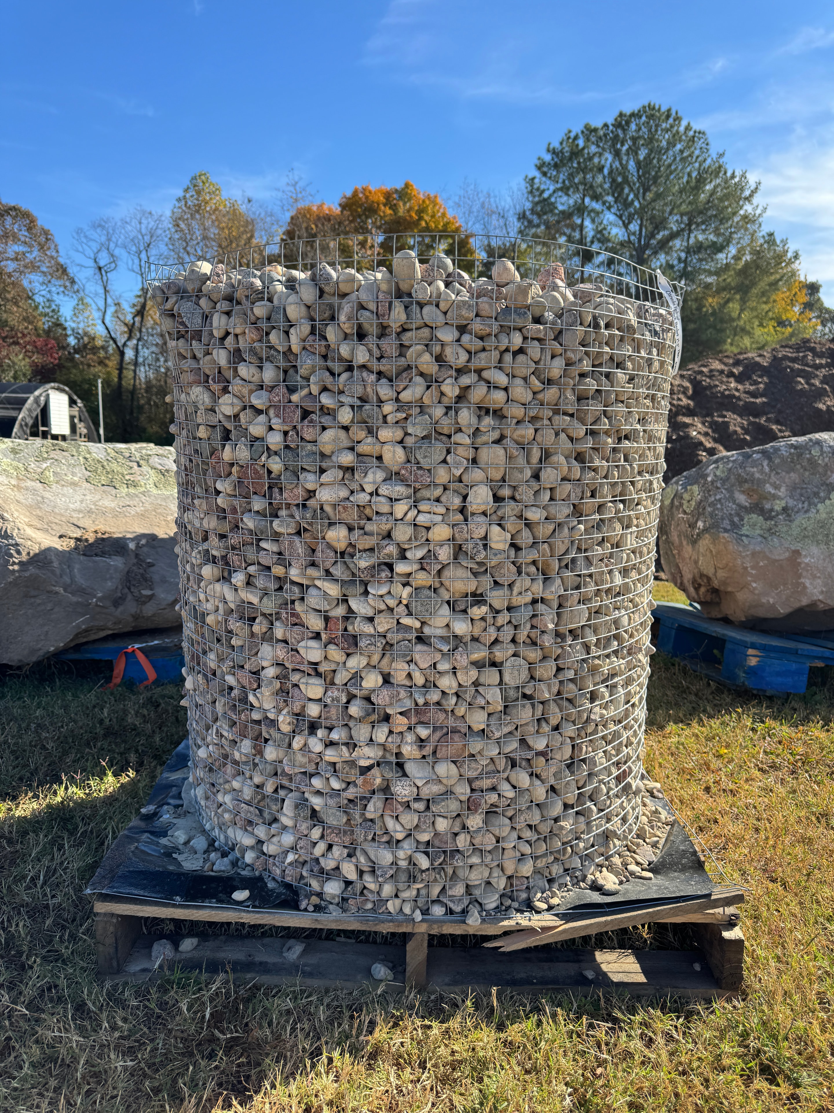 Wire cage pallet of Patriot Rock river pebbles