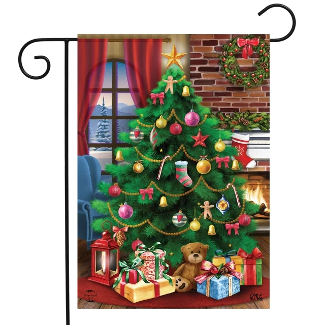 Decorated Christmas Tree garden flag with a trimmed tree, presents and a teddy bear by the fireplace