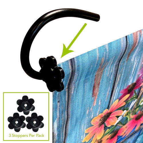 Three black flower-shaped flag stoppers shown holding a garden flag on a black pole