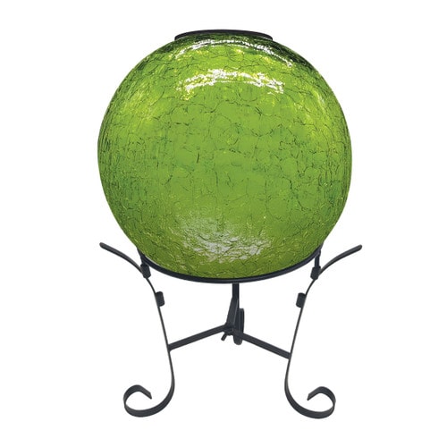Green cracked-glass gazing ball with solar LED light on a black metal scroll-foot stand